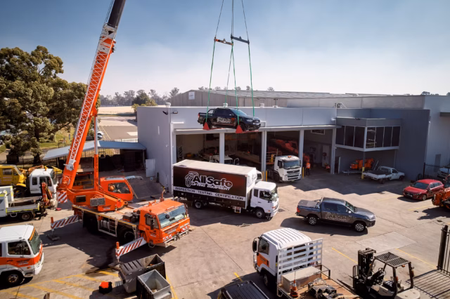 Car being lifted by crane drone photography by Sky Monkey