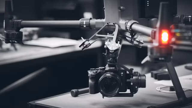 Creative black and white photography of a full frame Sony A7R4 camera connected to a heavy lifter drone by Sky Monkey